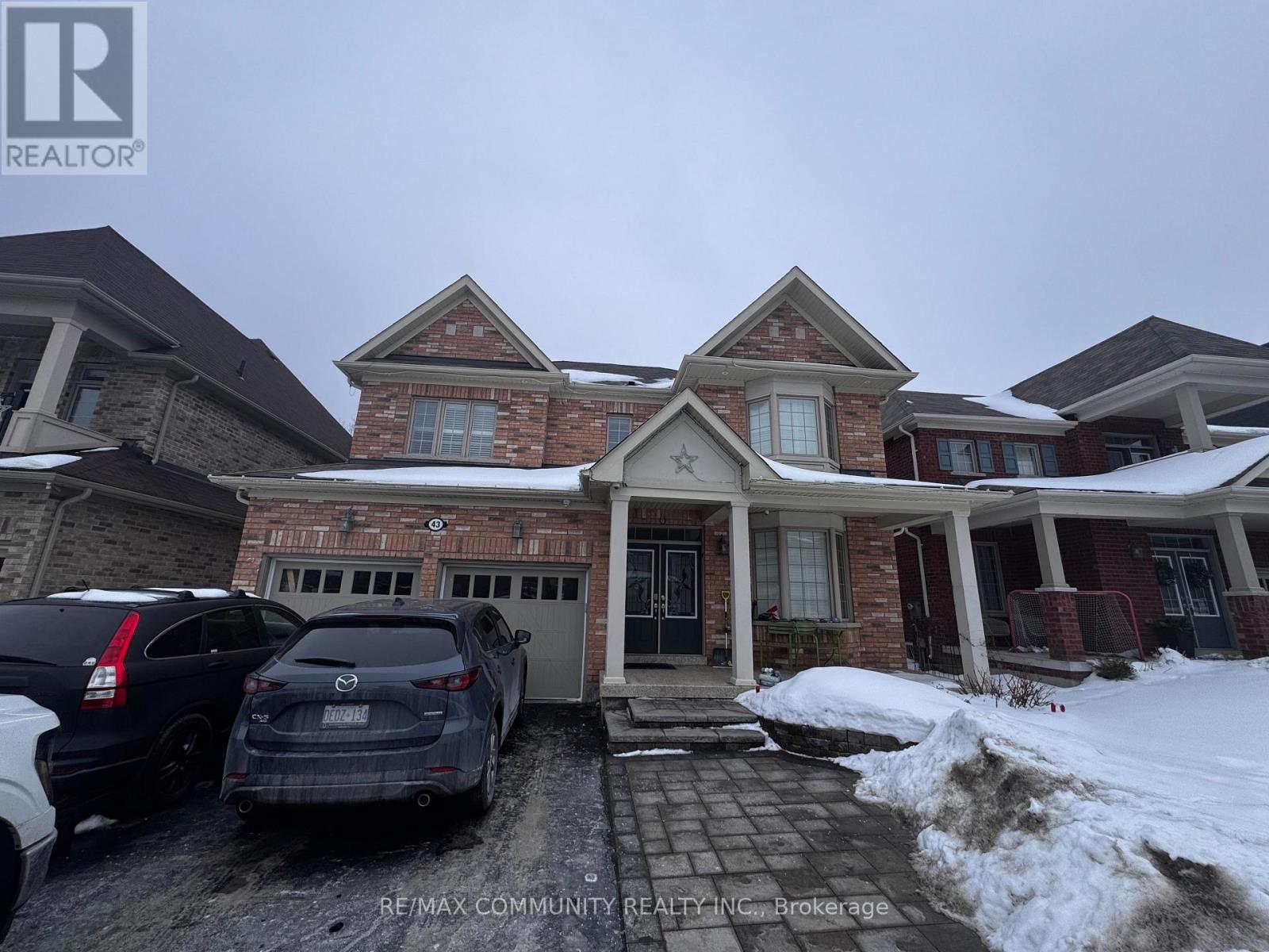 A house with a car parked in front of it.