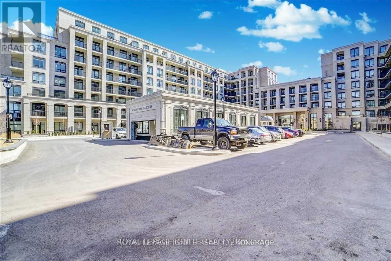 A parking lot in front of a building with a sign that says "RHALTOR".