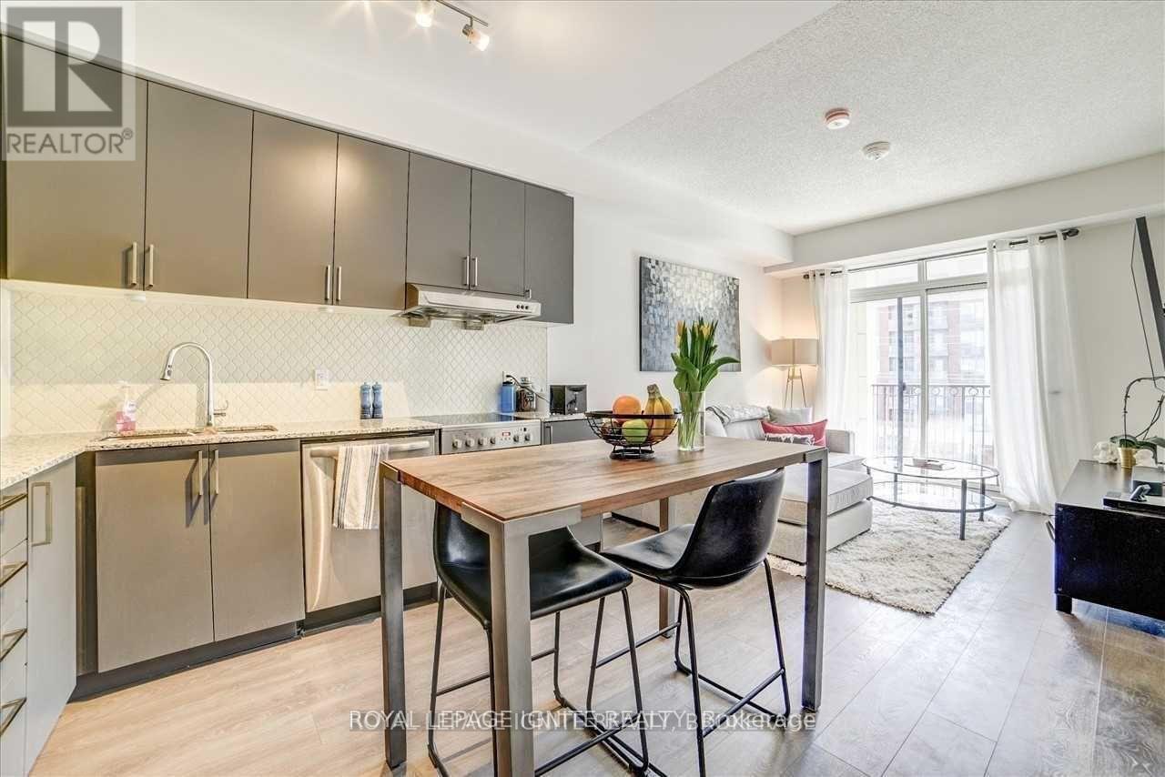 A modern kitchen with a dining table and chairs.