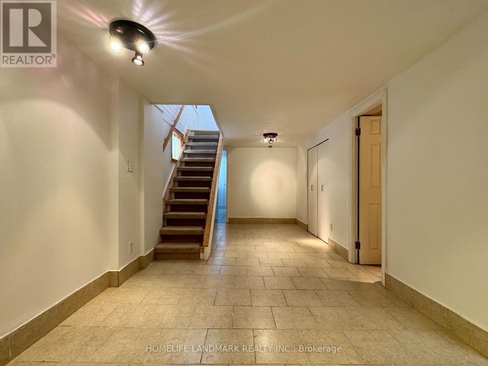 A spacious hallway with a staircase leading to the second floor.