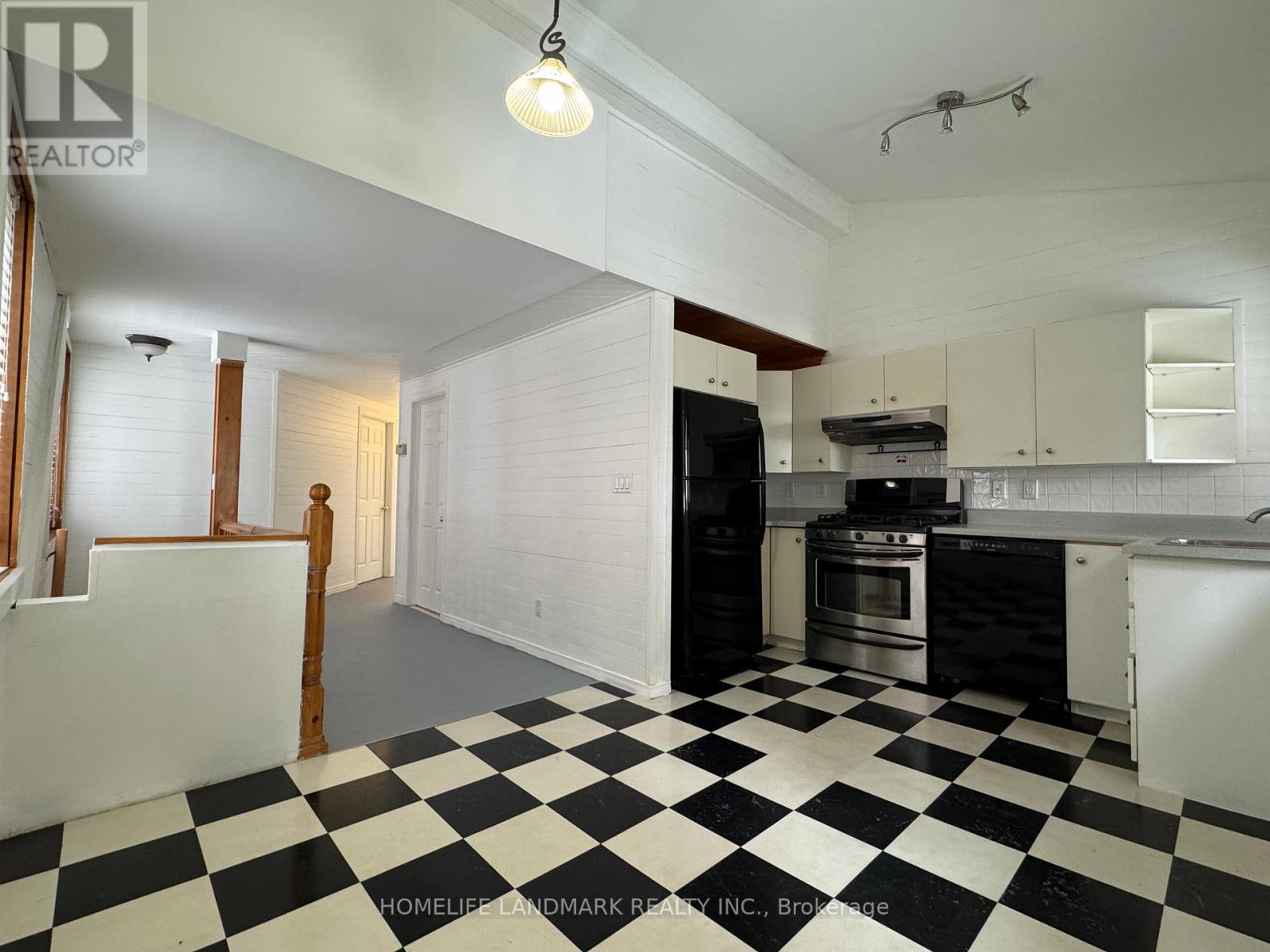 A black and white checkered floor in a kitchen.