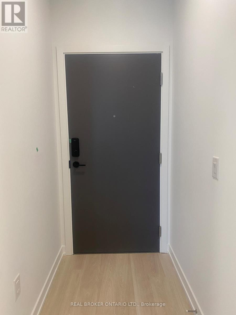 A black door with a handle and a small square on the door.