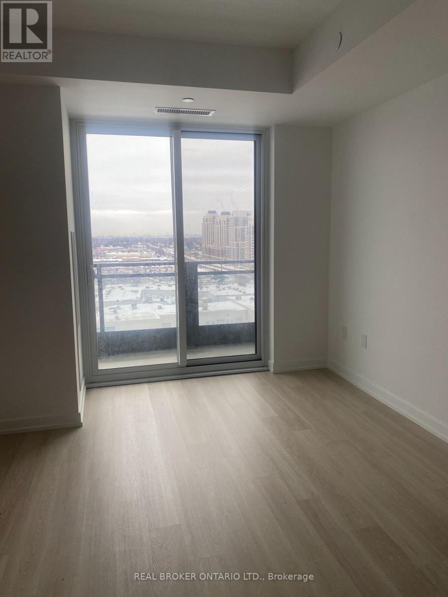 A room with a view of a cityscape through a large window.