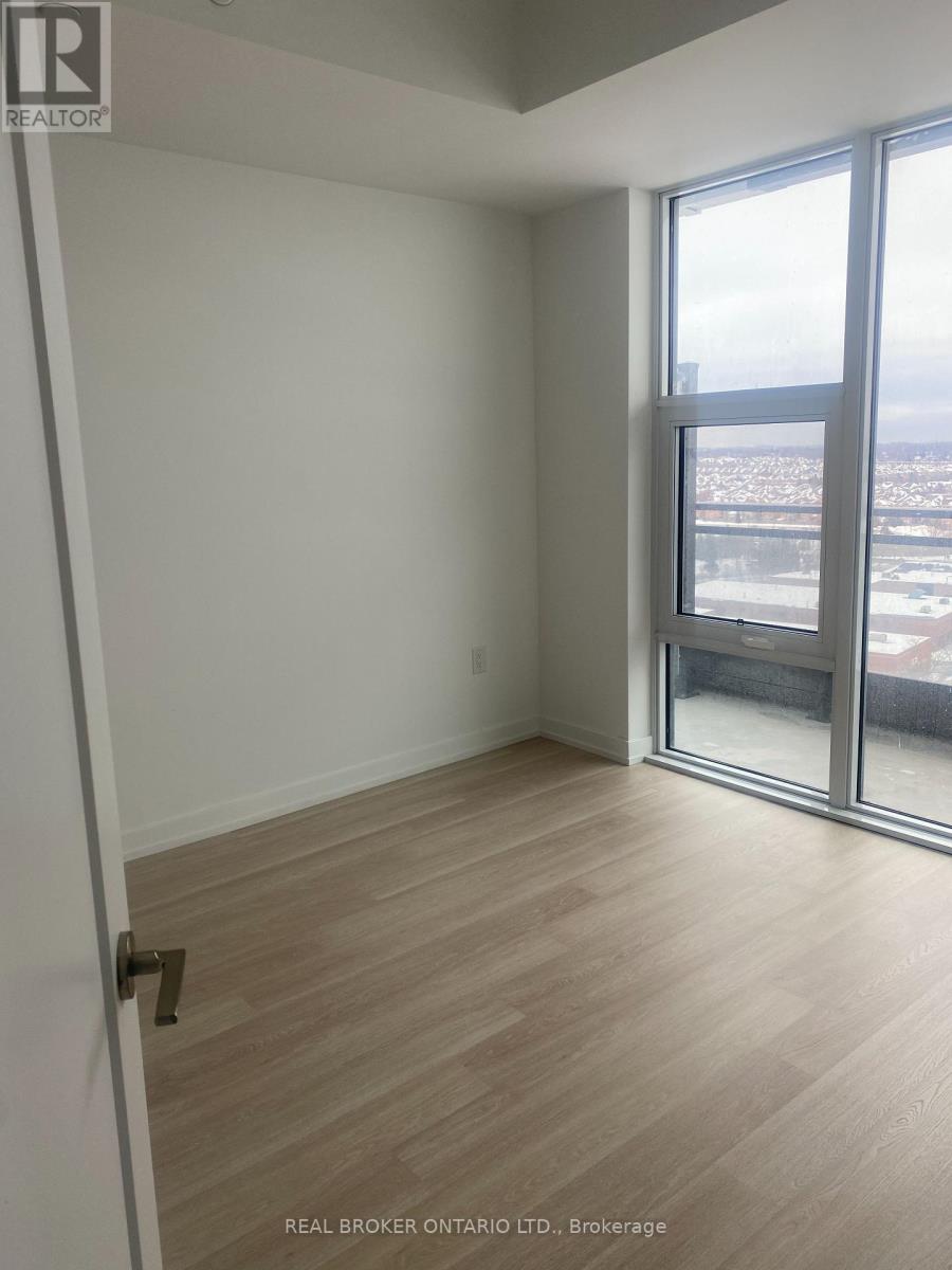 A room with a sliding glass door leading to a balcony.