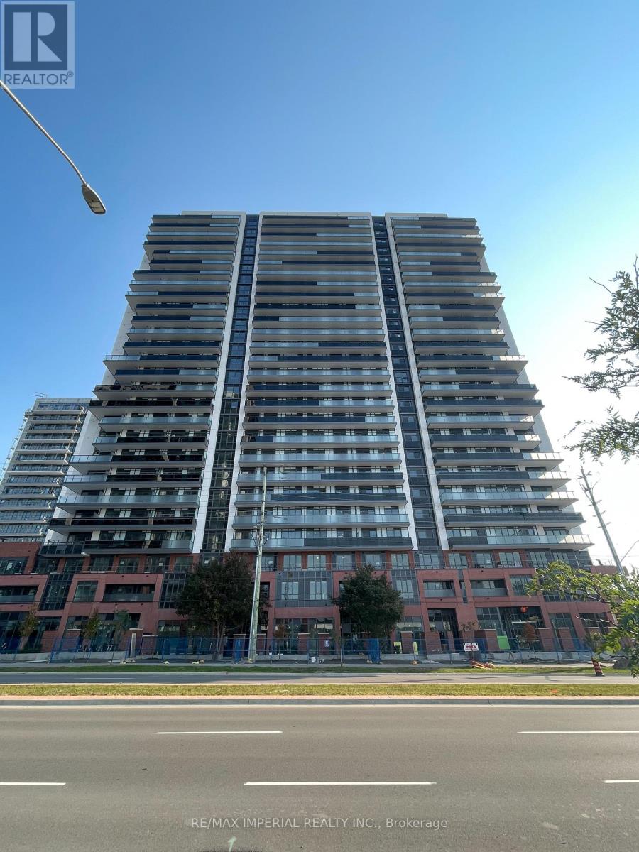 A tall apartment building with a clear blue sky in the background.