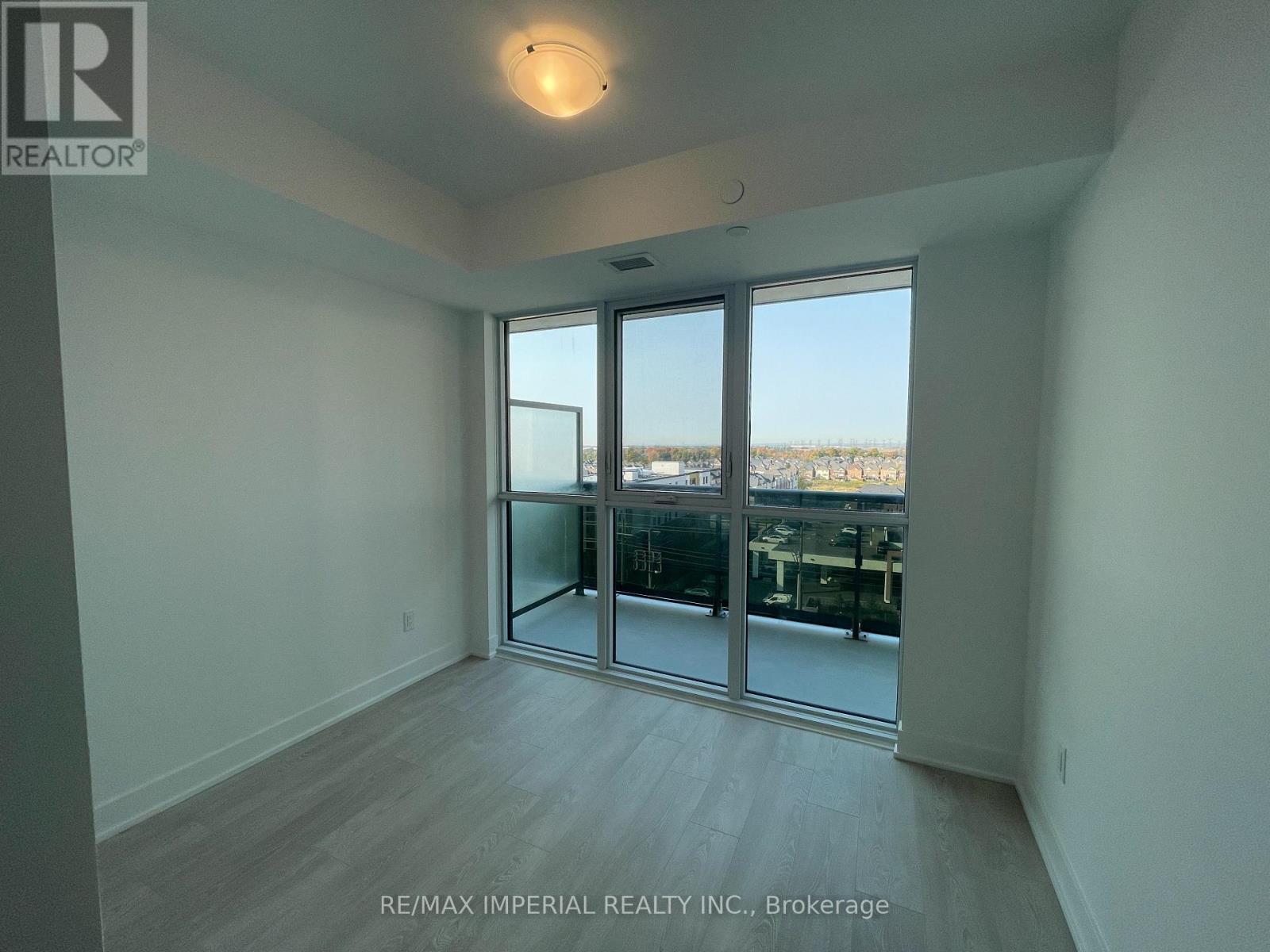 A room with a sliding glass door leading to a balcony.