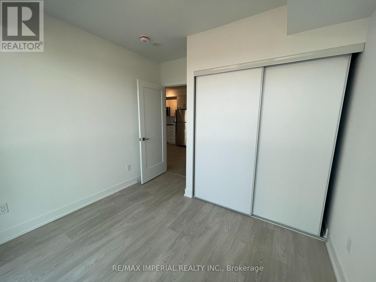 A room with a sliding door and a wooden floor.