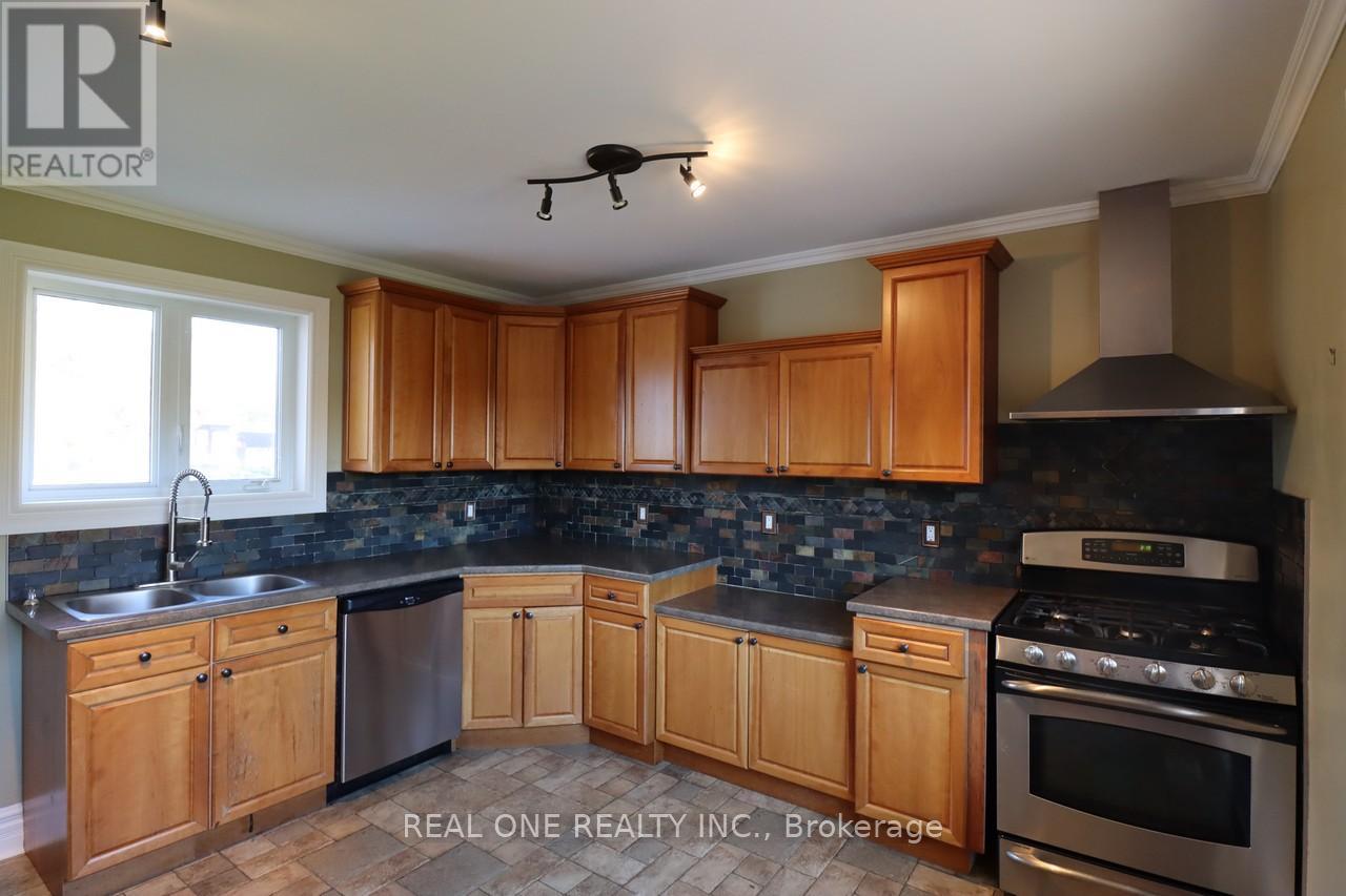 A kitchen with wooden cabinets and a black stove top oven.