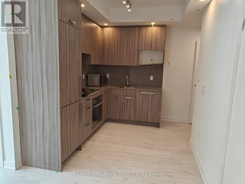 A modern kitchen with wooden cabinets and appliances.