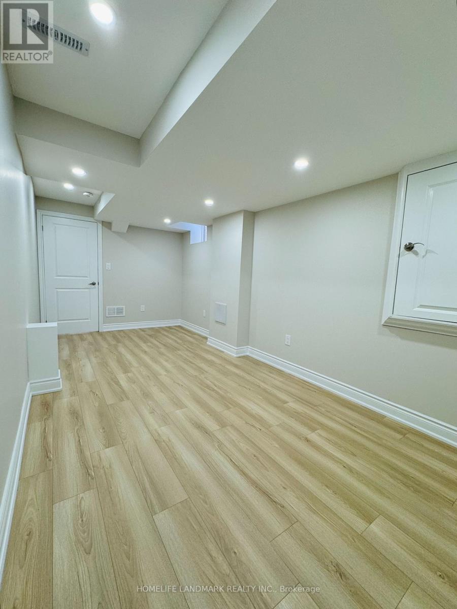 A room with wooden flooring and white walls.