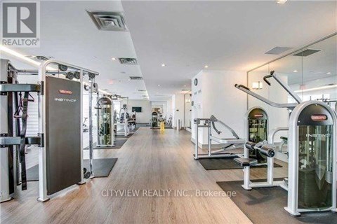 A gym with a variety of equipment including treadmills, weights, and exercise machines.
