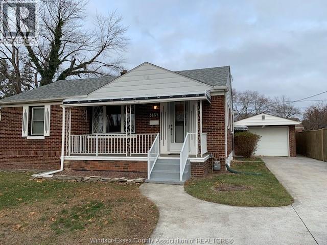 A house with a front porch and a garage is shown.