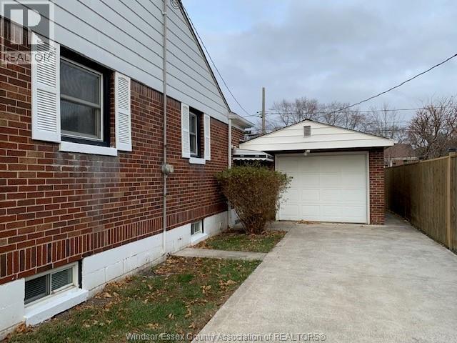 A house with a garage and a driveway in front.