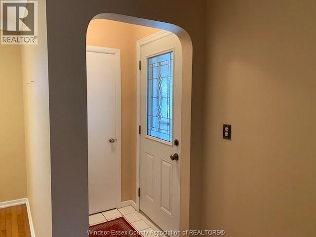 A white door with a glass window is in a hallway.