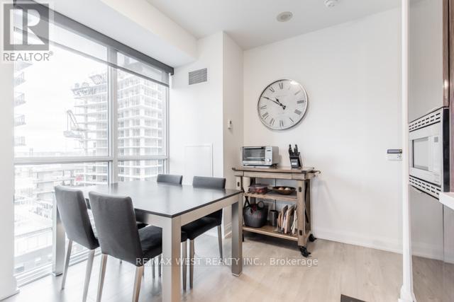 A modern kitchen with a dining table and chairs.