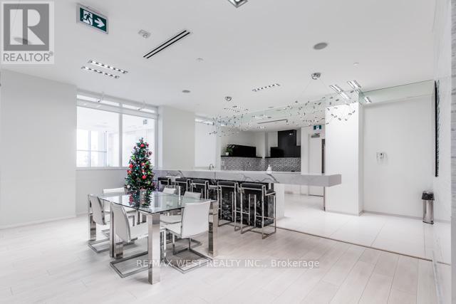 A modern dining room with a glass table and chairs.