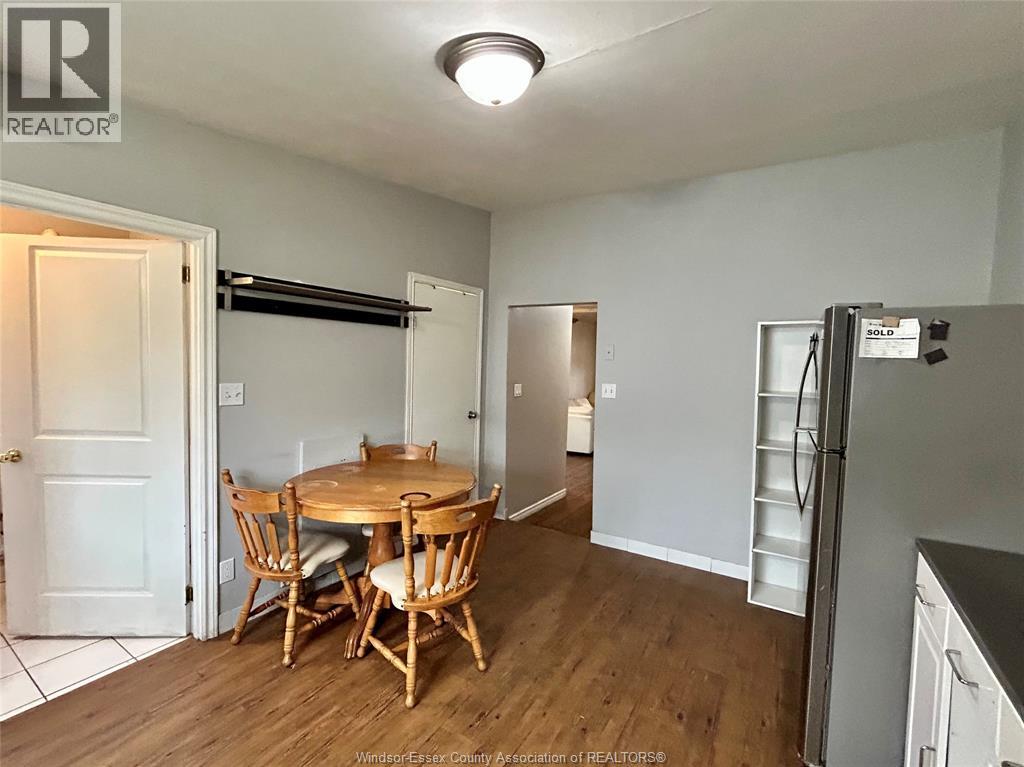 A kitchen with a table and chairs in the middle of the room.