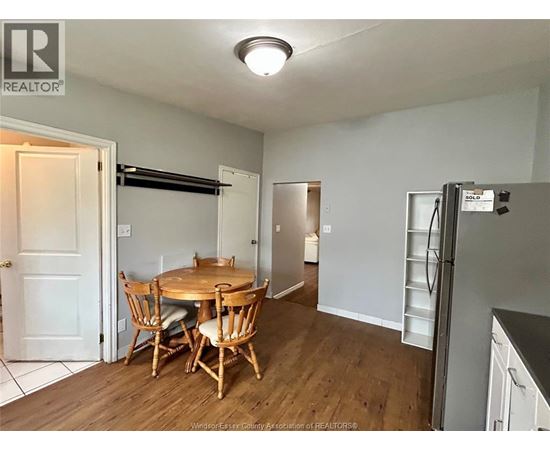 A kitchen with a table and chairs in the middle of the room.