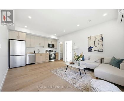 A modern kitchen with a large island and stainless steel appliances.