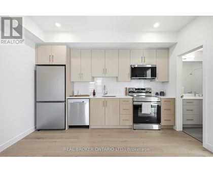 A modern kitchen with a stainless steel sink and appliances.