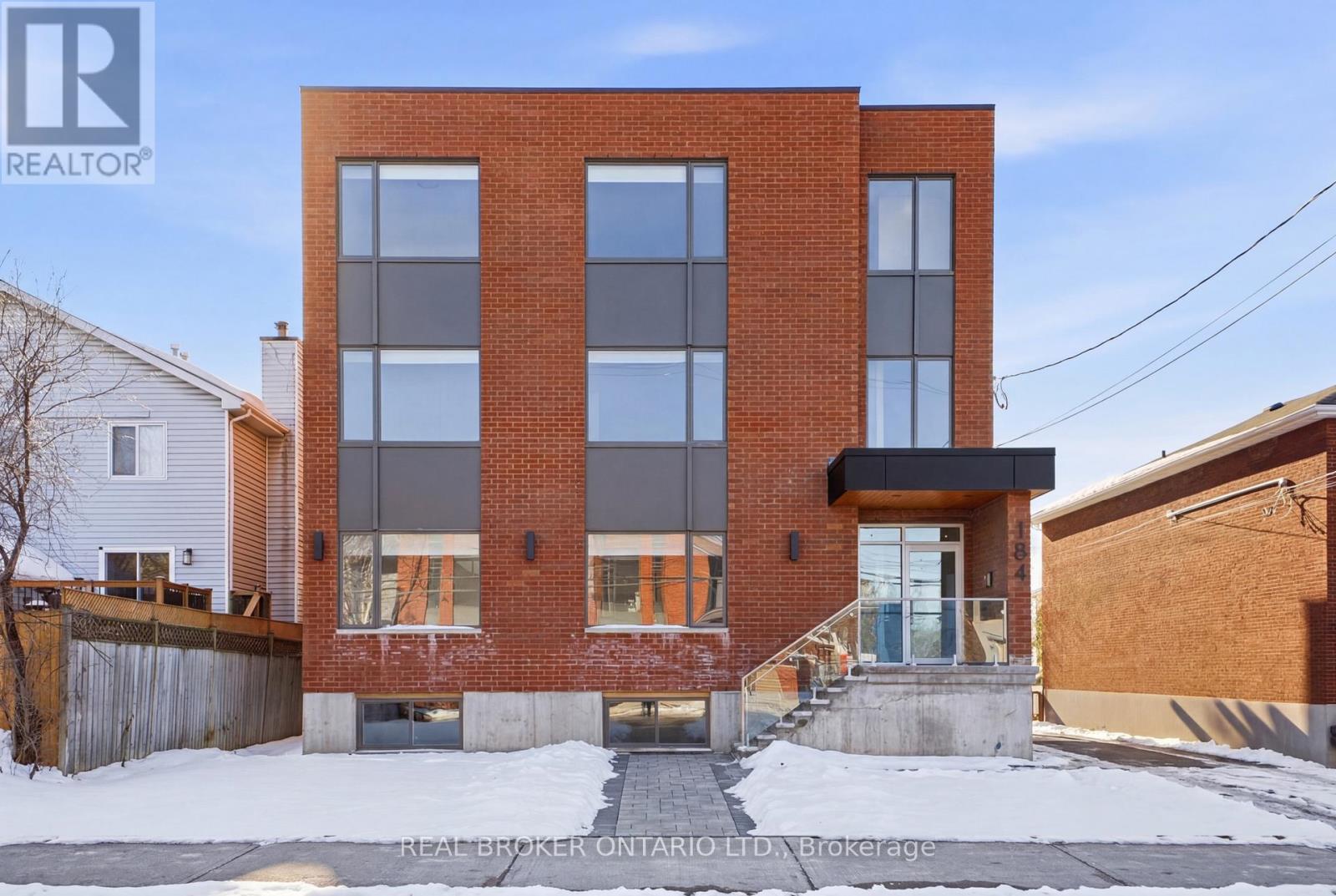 A building under construction with the words "Real Broker" written on the top left corner.
