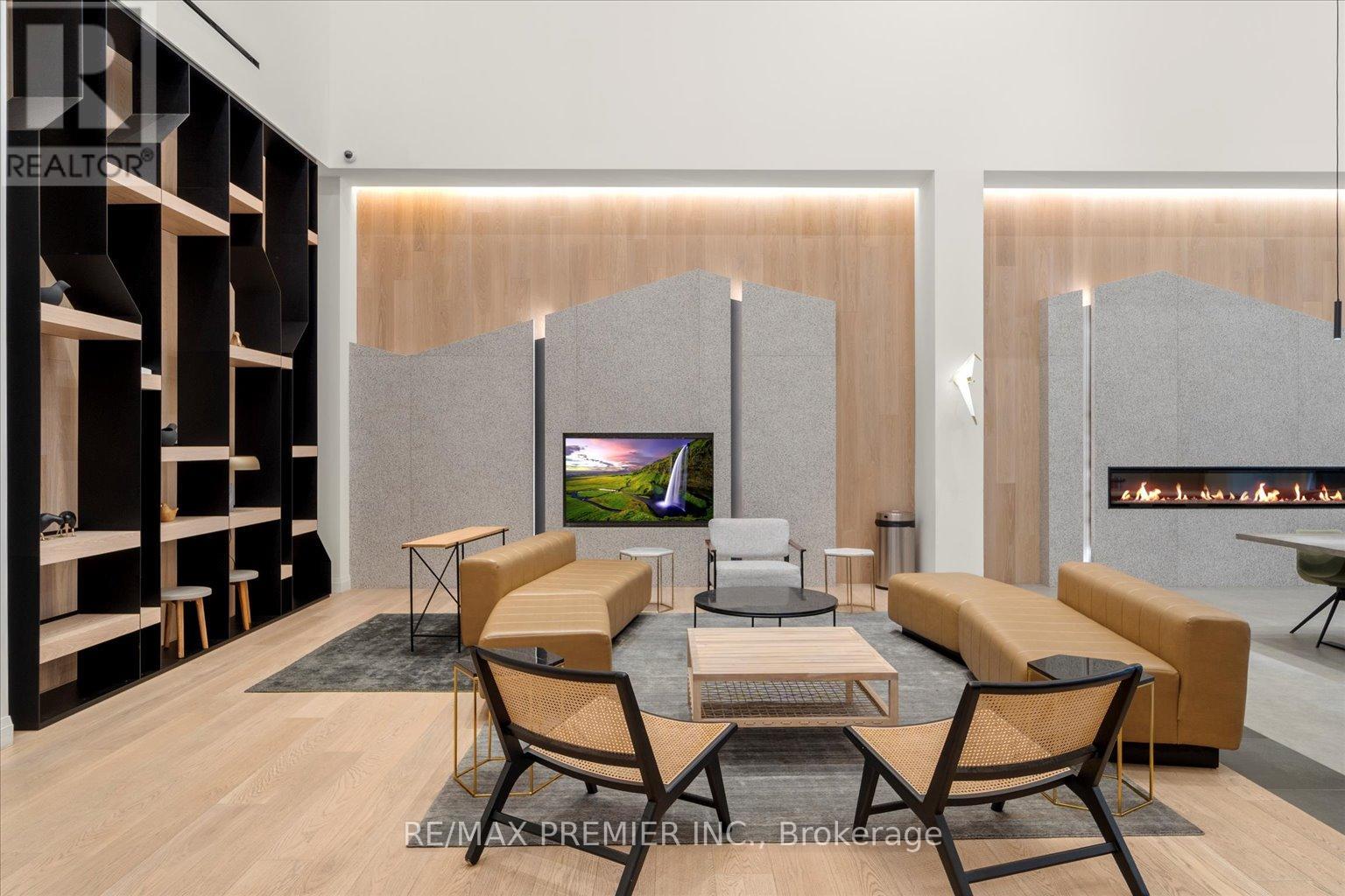 A modern living room with a television and a fireplace.