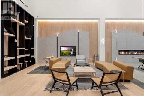 A modern living room with a television and a fireplace.