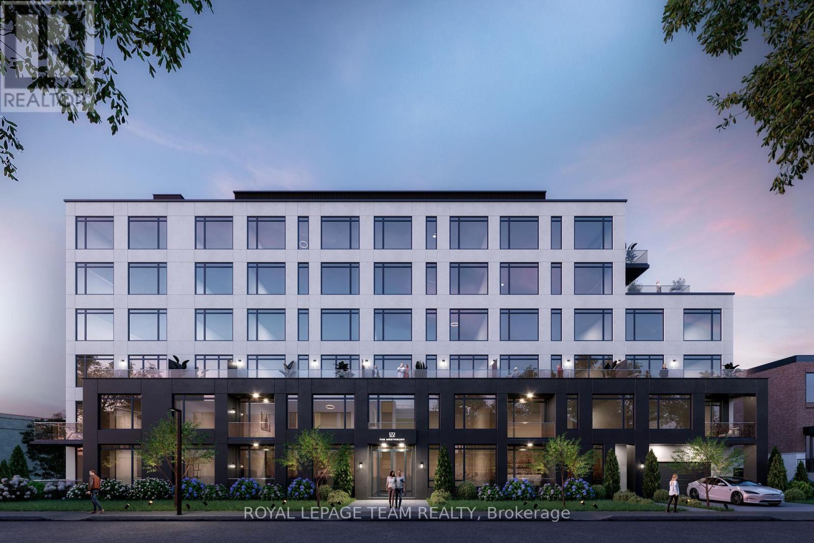 A modern building with a sign that reads "Royal LePage Team REALTY, Brookeage" in front of it.