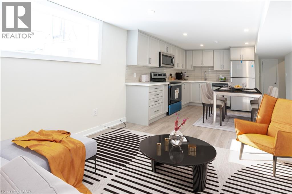 A modern kitchen with a dining area and a living room.