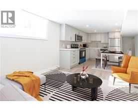 A modern kitchen with a dining area and a living room.