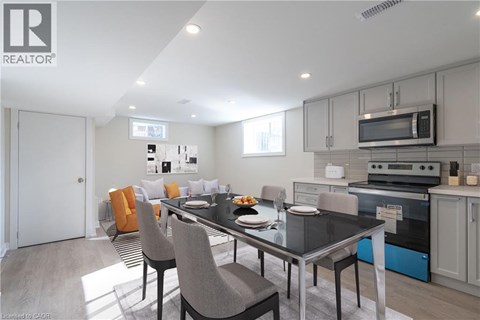 A modern kitchen with a dining table set for four.