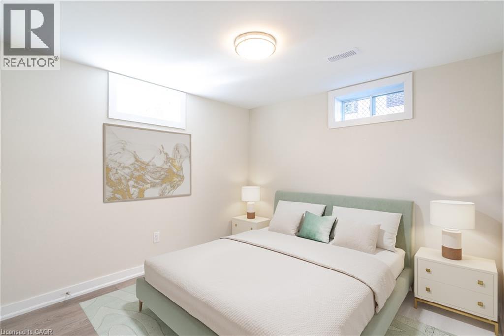 A bedroom with a bed, nightstands, and a painting on the wall.