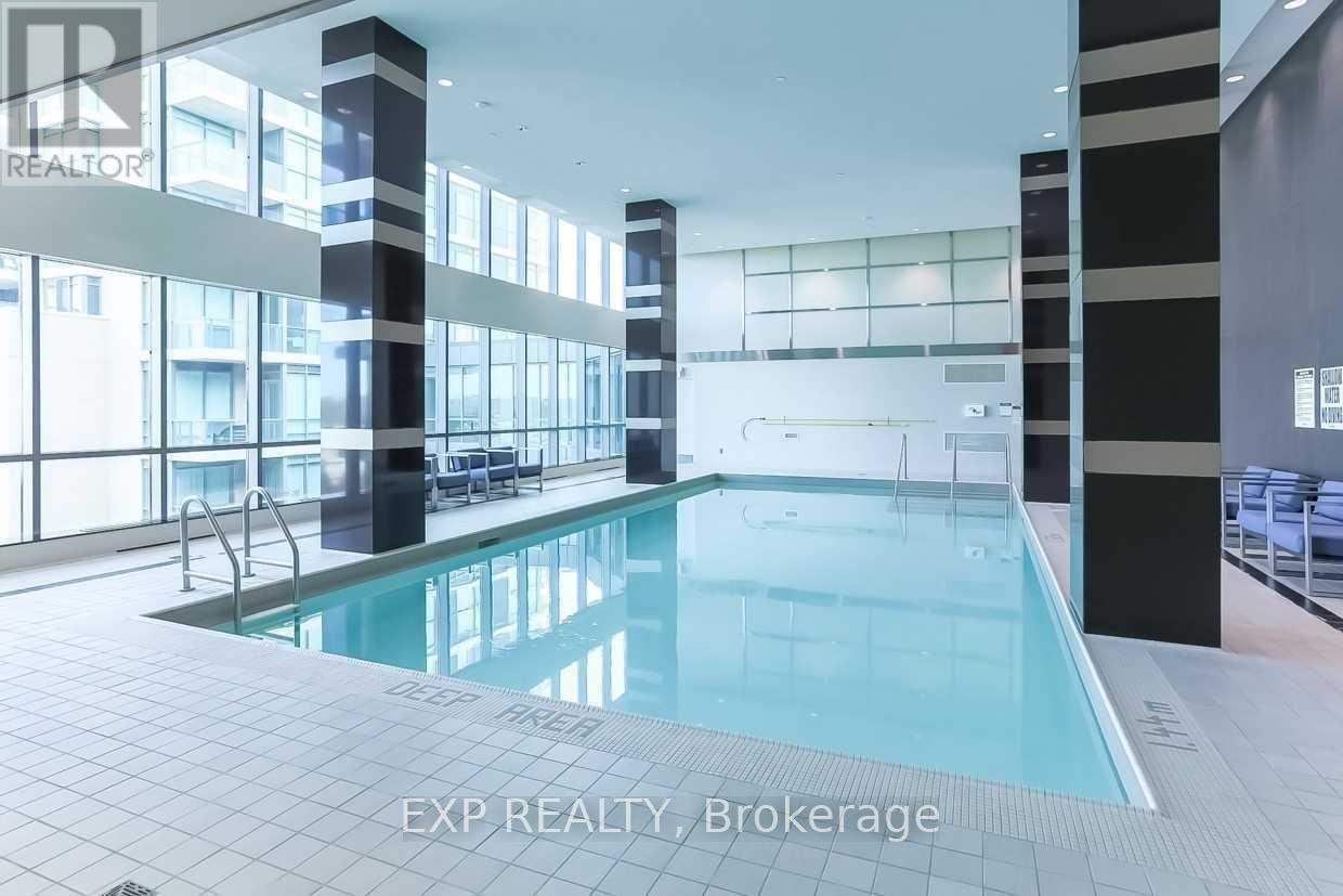 A swimming pool inside a building with the words EXP REALTY, Brokerage written on the bottom.