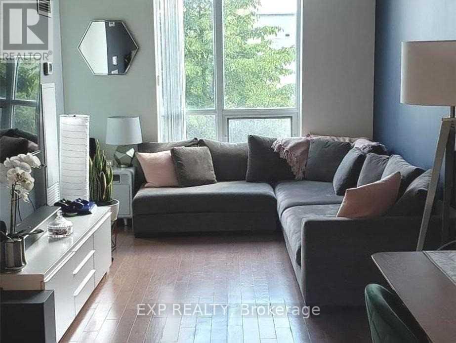 A living room with a grey couch and a wooden table.