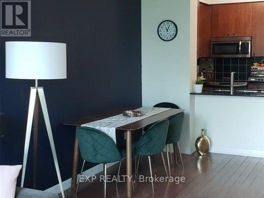 A dining area with a table, chairs, and a lamp.