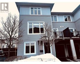 A blue house with a sign that says "REALTOR" in the top left corner.