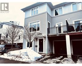 A house with a grey and white exterior and a balcony.