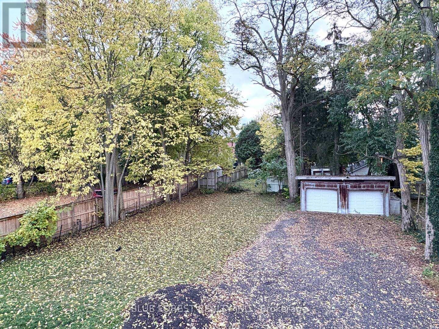 A backyard with a pathway and a garage.