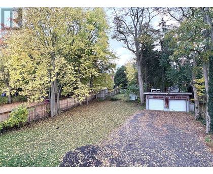 A backyard with a pathway and a garage.