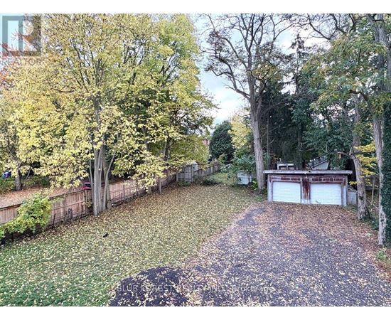 A backyard with a pathway and a garage.
