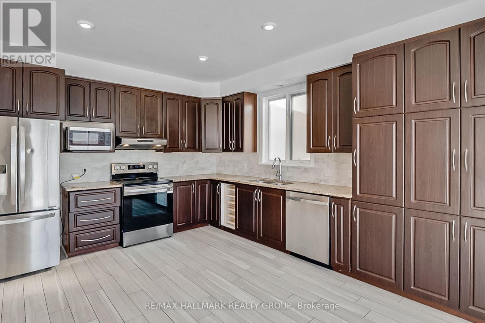 A kitchen with brown cabinets and a white fridge.