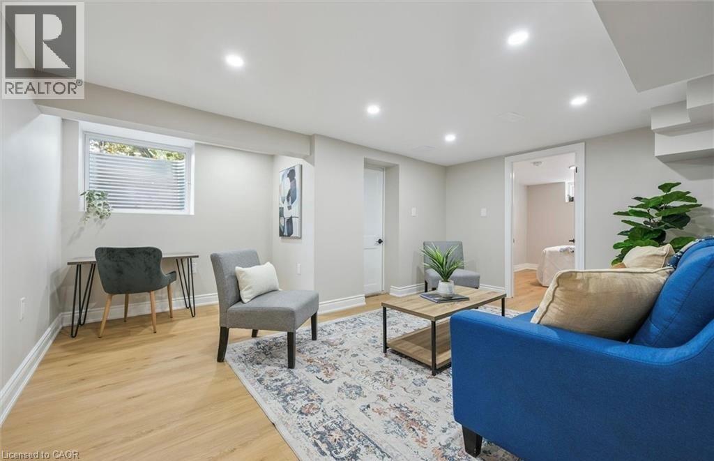 A living room with a blue couch and a rug.