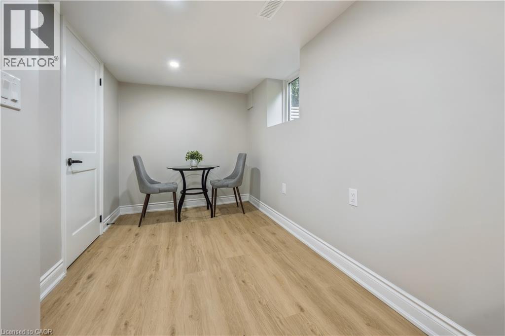 A dining room with a table and chairs.