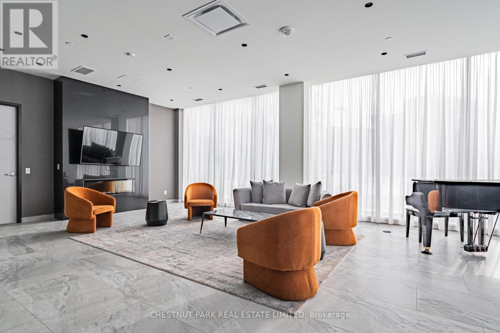 A modern living room with a piano and a TV.