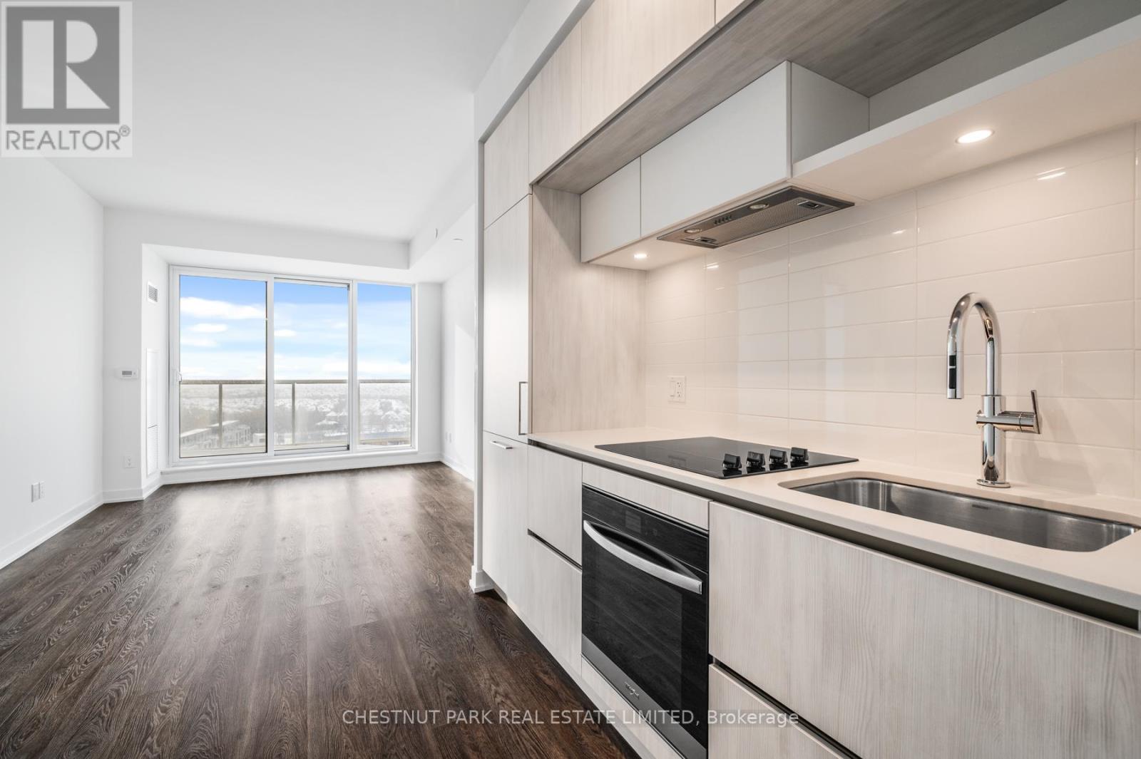 A modern kitchen with a stainless steel stove and sink.
