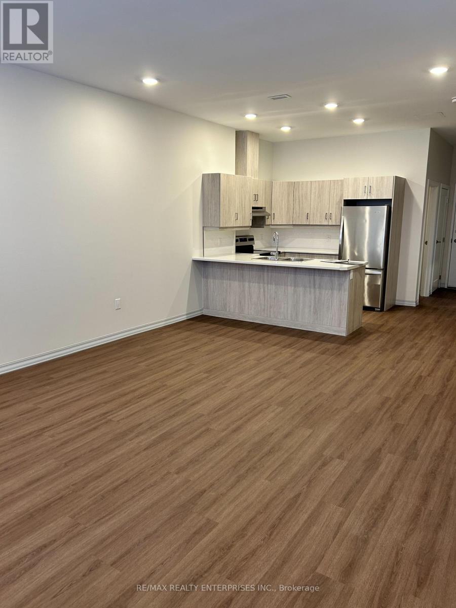 A kitchen with wooden floors and white walls.
