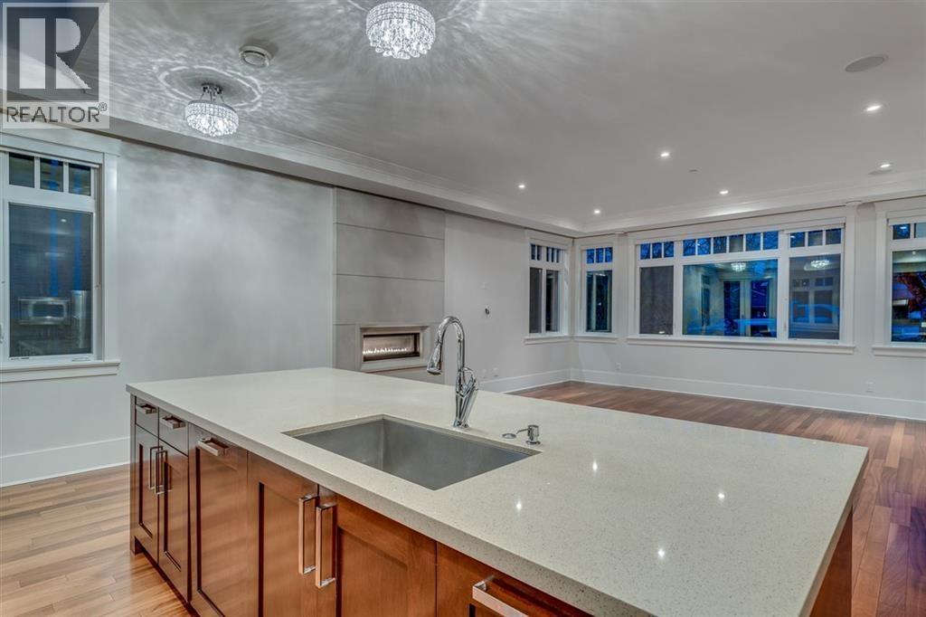 A modern kitchen with a large island and wooden cabinets.
