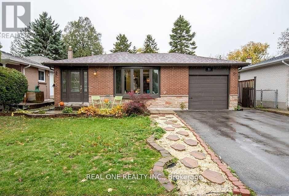 A house with a brick facade and a stone pathway leading to the garage.