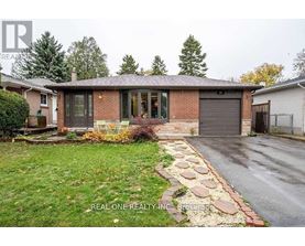 A house with a brick facade and a stone pathway leading to the garage.