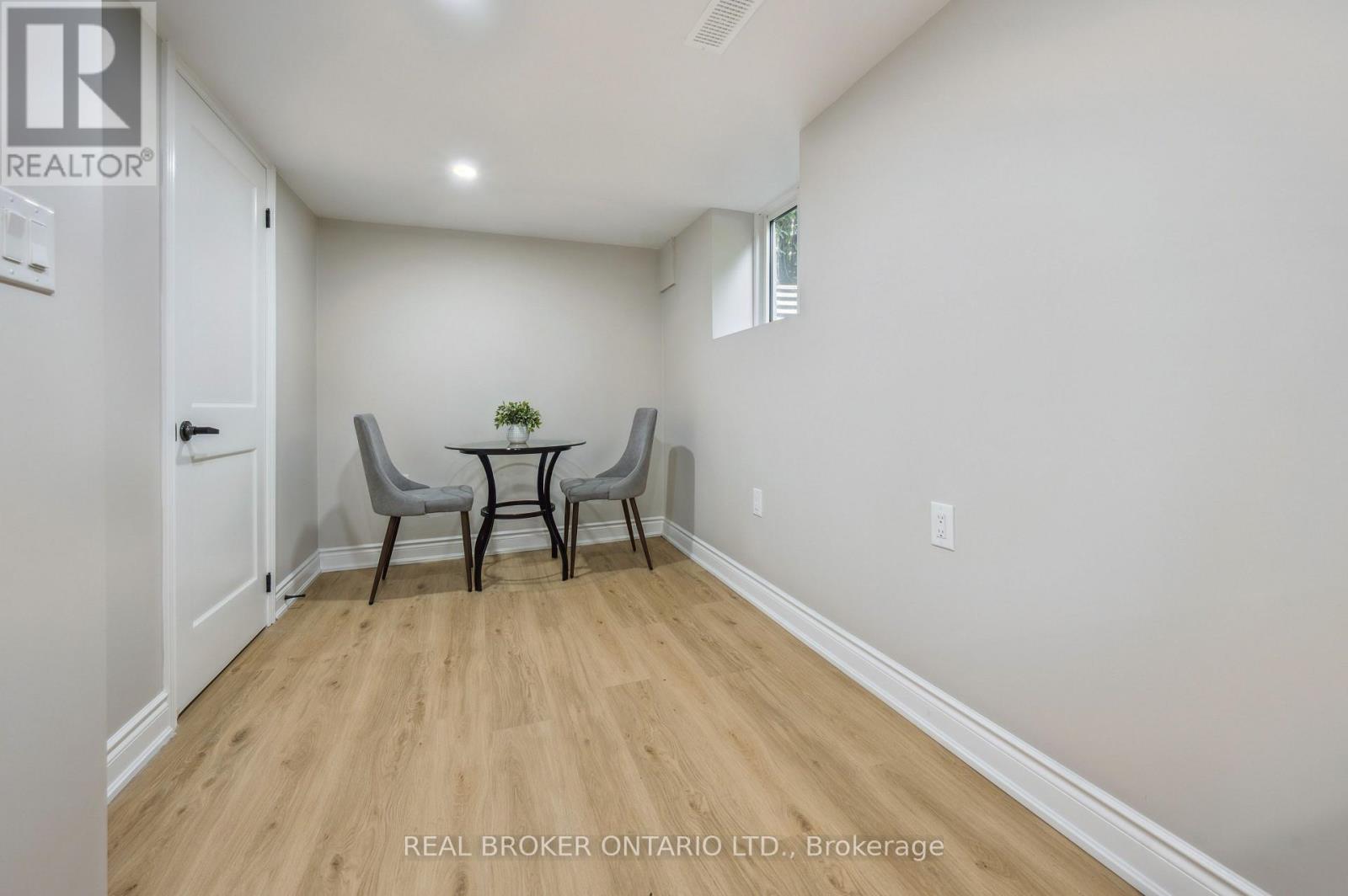 A dining room with a table and chairs.
